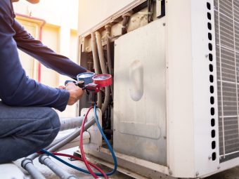 A technician checking an AC unit