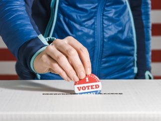 Woman voting with American flag